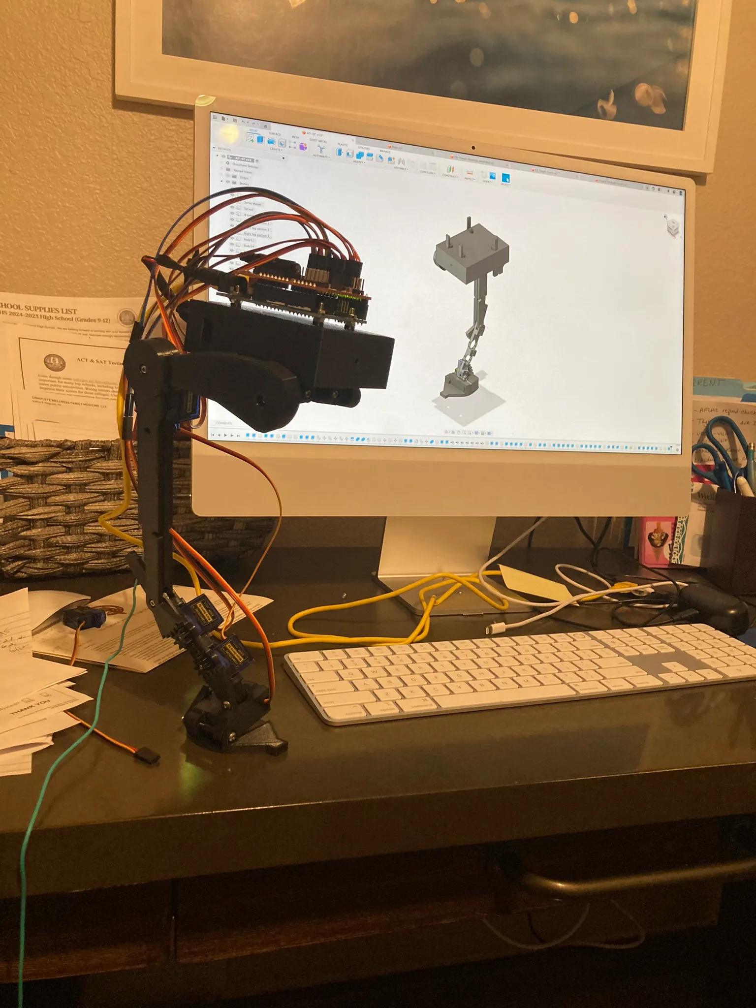 The assembled hardware in front of the CAD model of the full walker