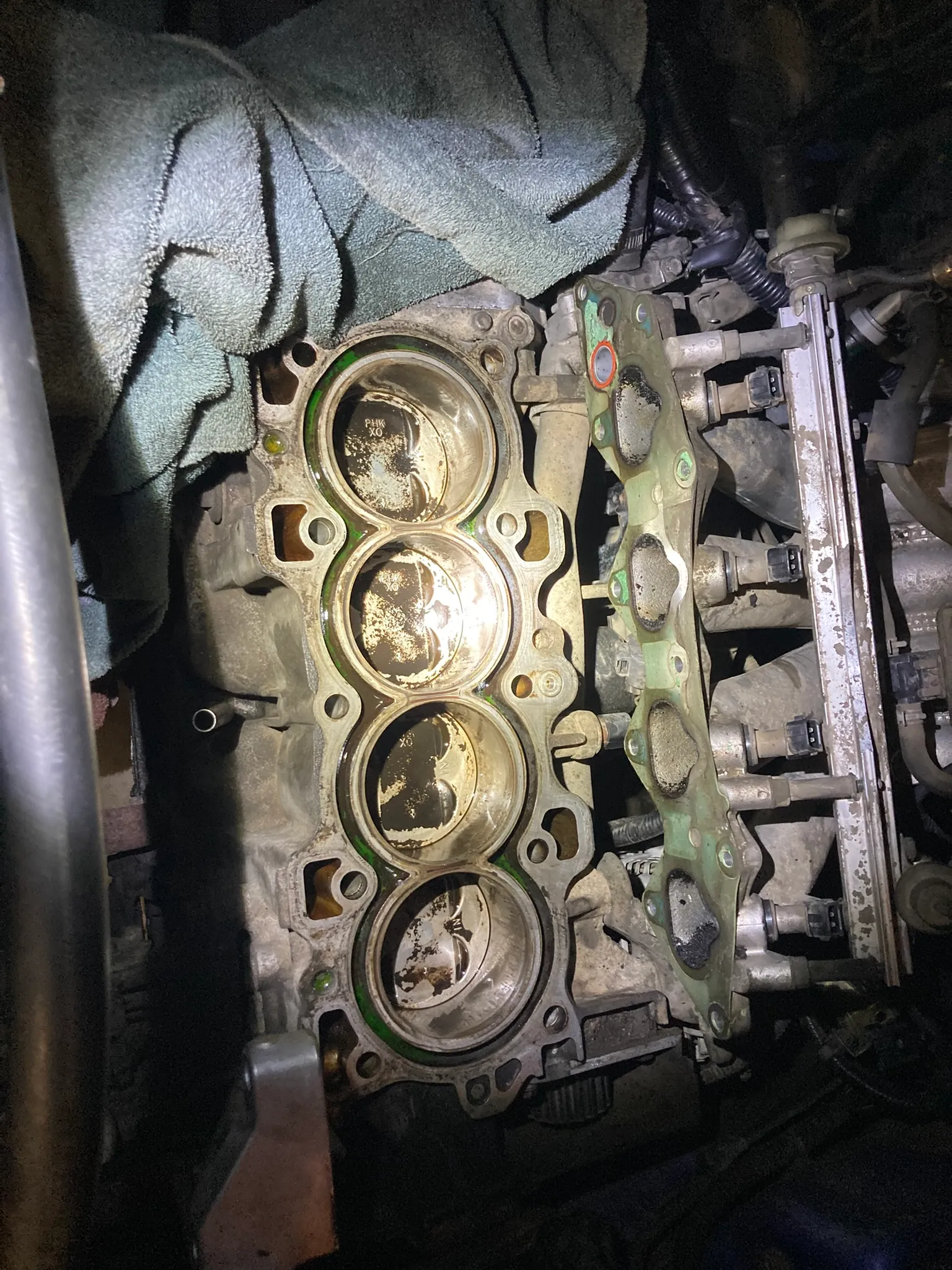 Engine block with the head removed, showing the four piston crowns