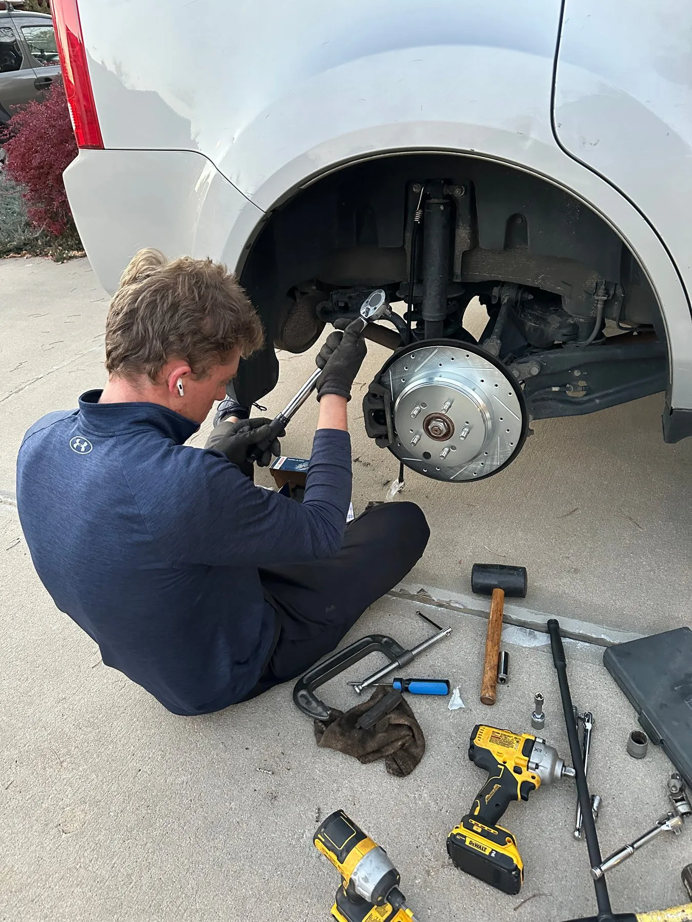 Torquing the caliper bolts on a new slotted and drilled brake rotor