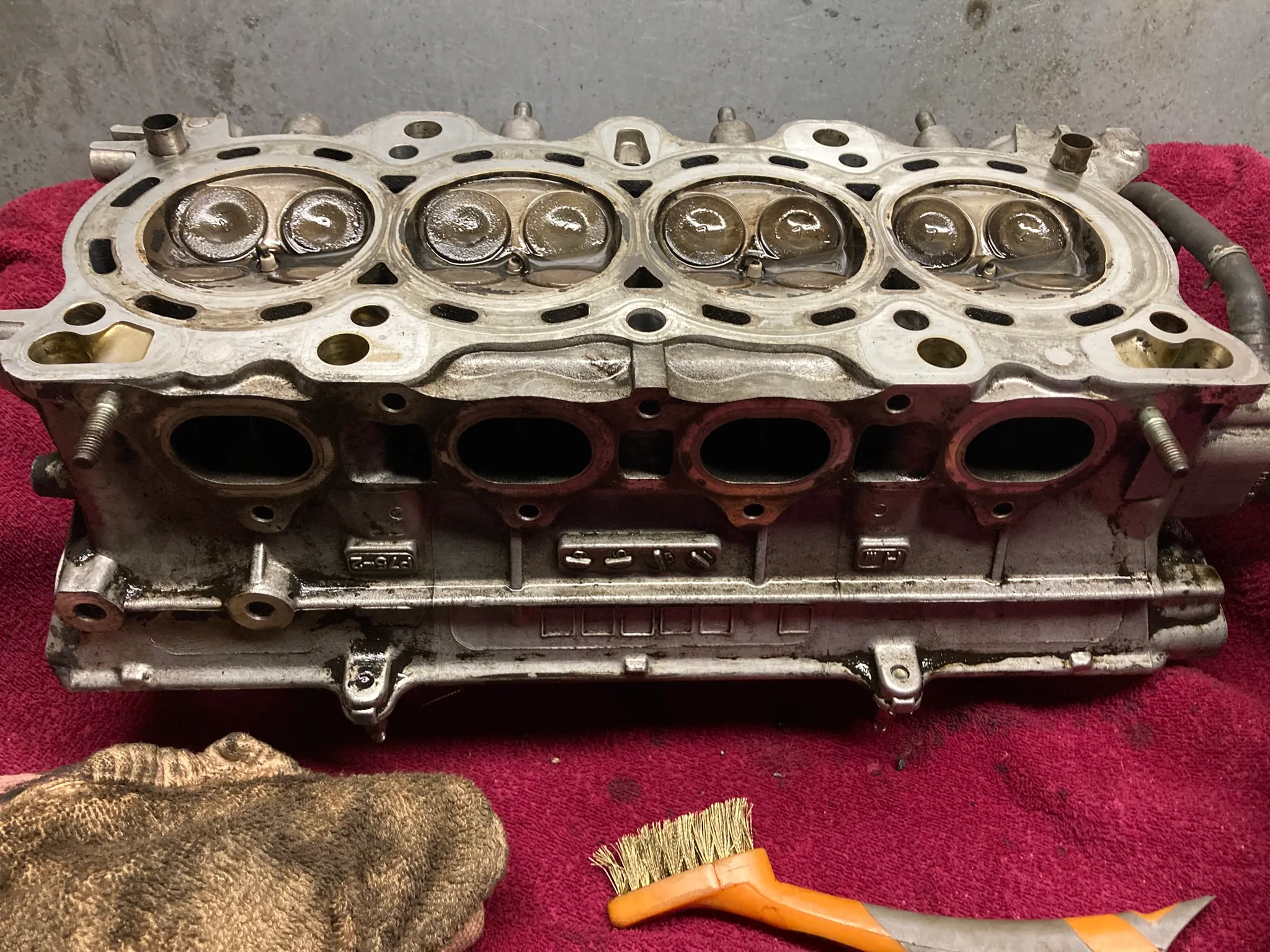 Cleaned cylinder head from a 2001 Honda CR-V resting on a workbench