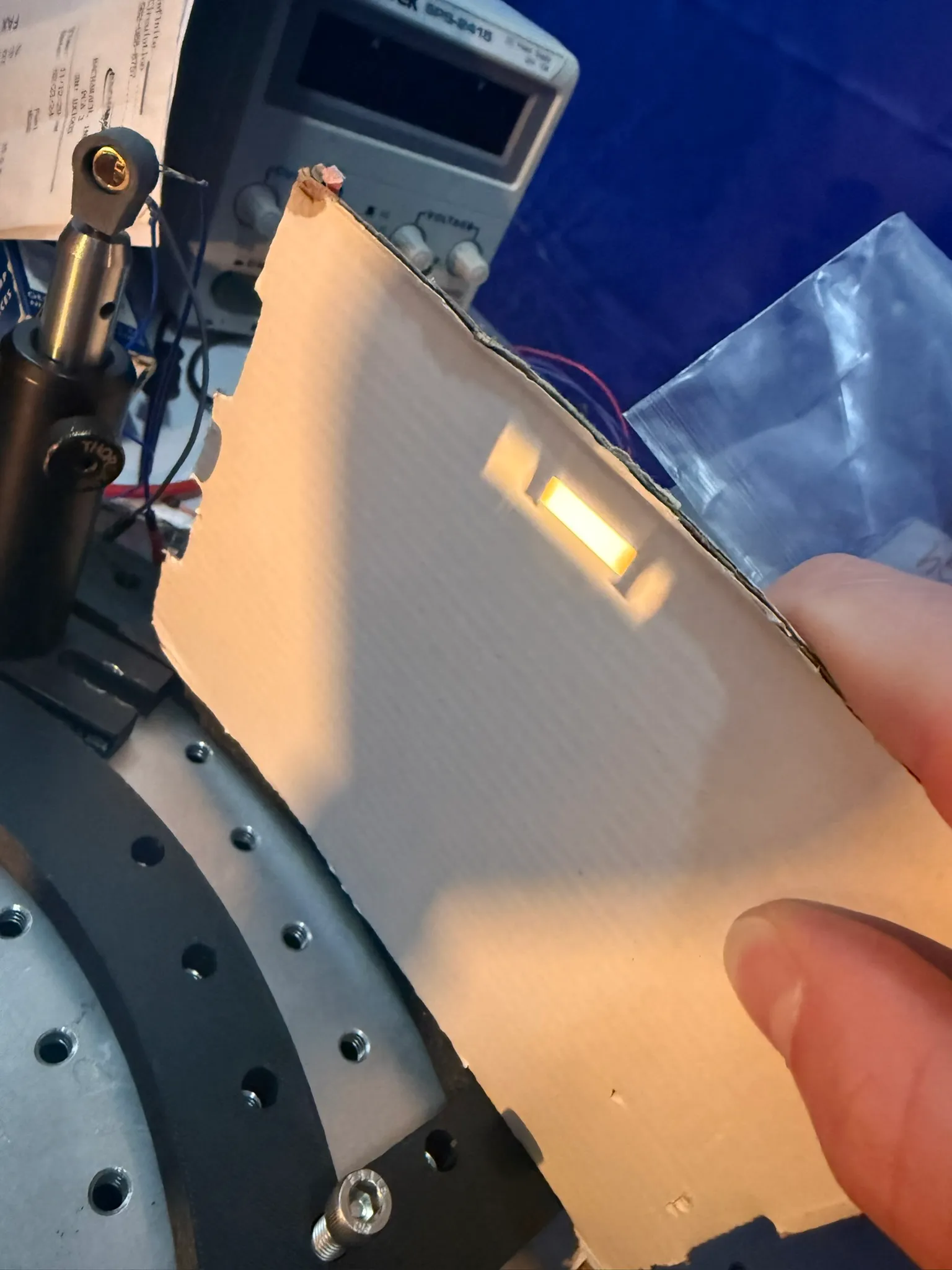 The projected filament image landing on a card in the beam path