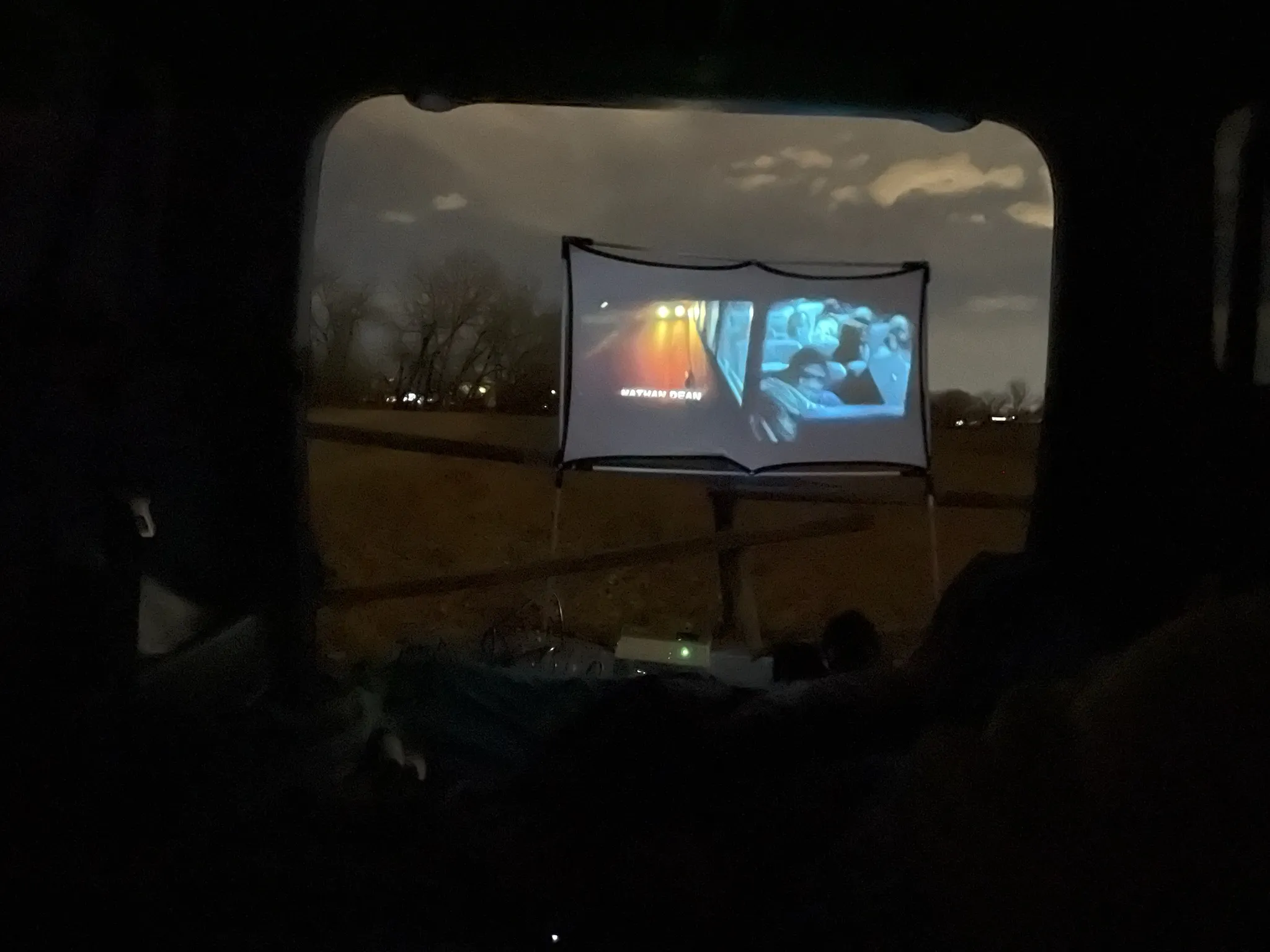 The view from inside the car: a movie playing on the screen through the windscreen