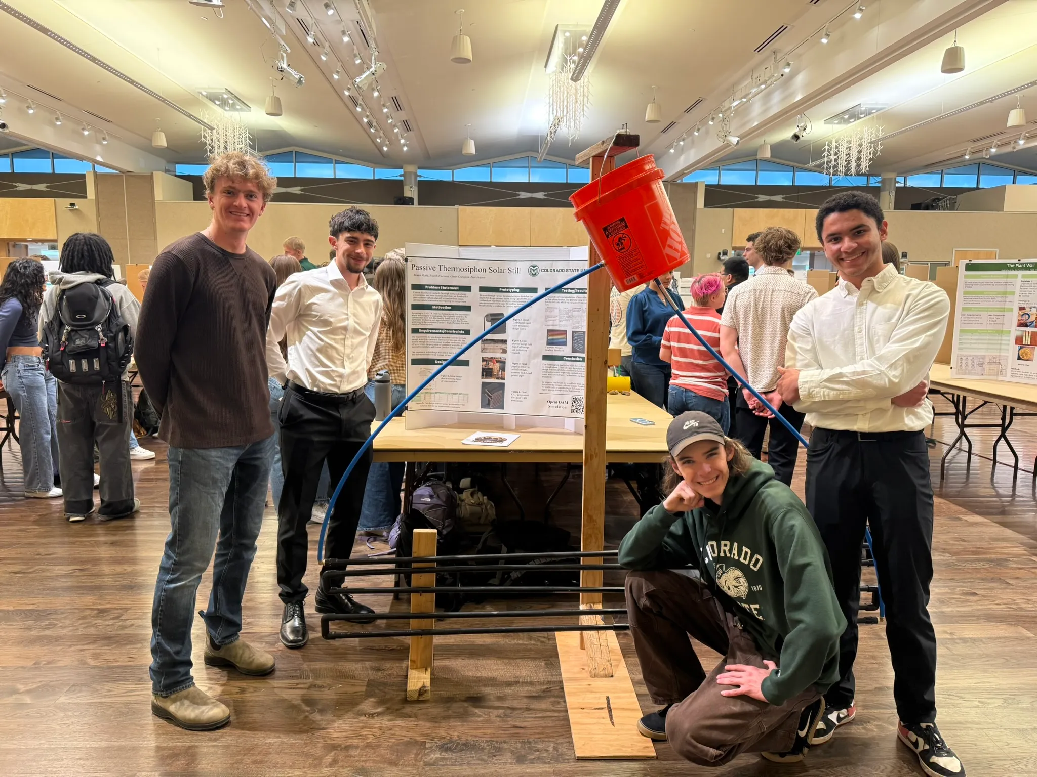 The four-person team with the still at the expo