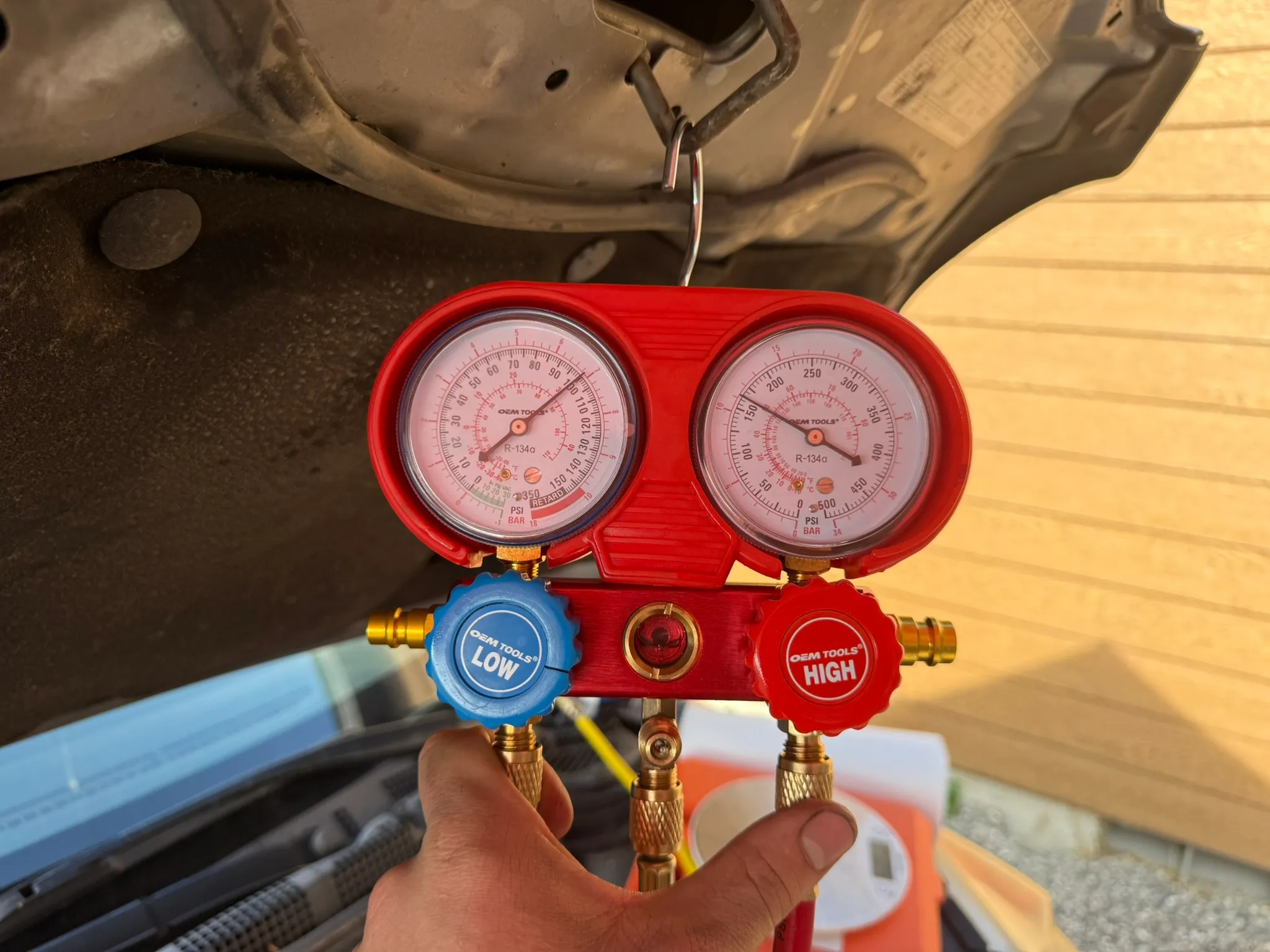 R-134a manifold gauge set connected to the low and high side ports