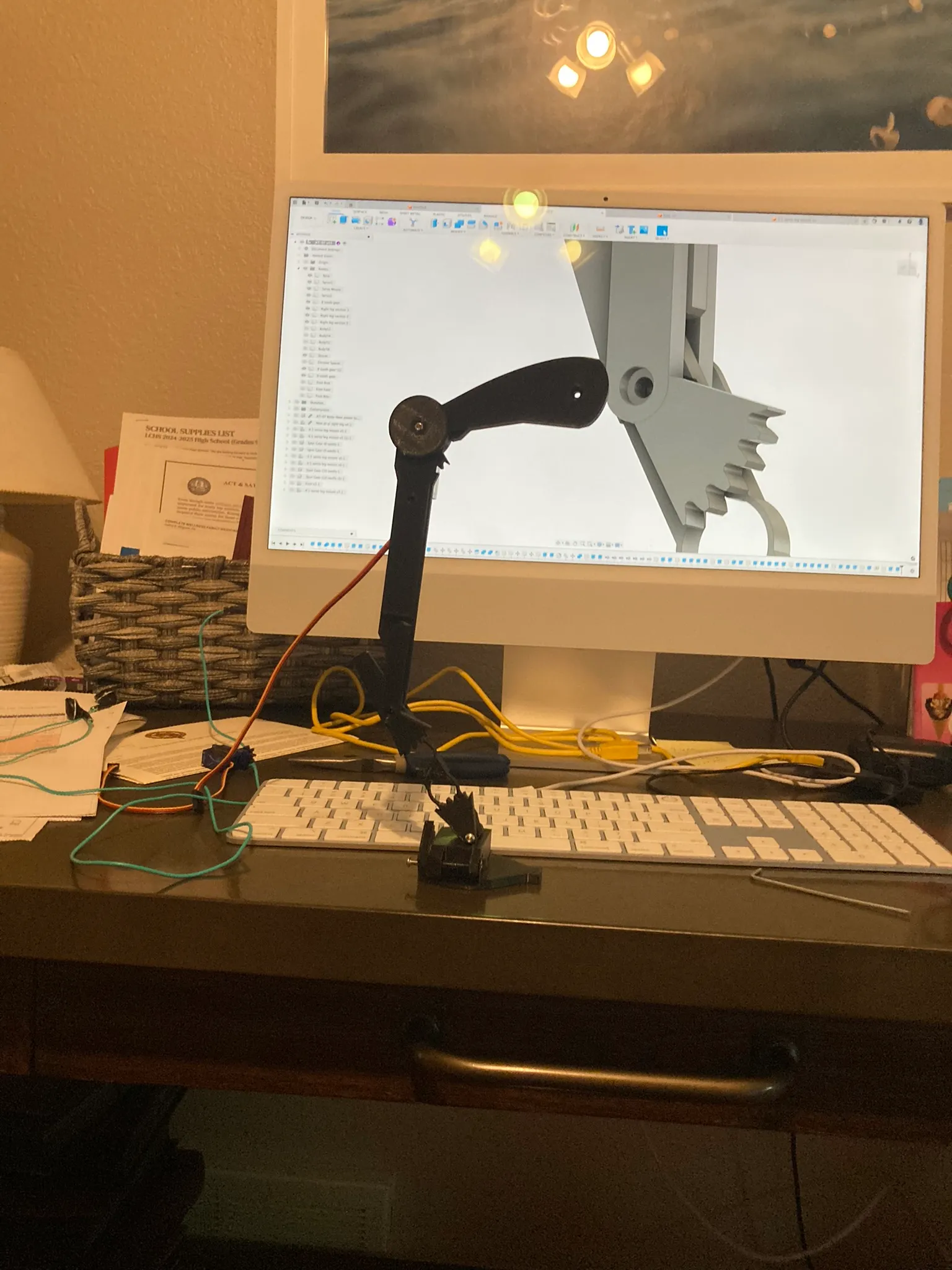3D-printed leg beside the Fusion 360 model of the same part on screen