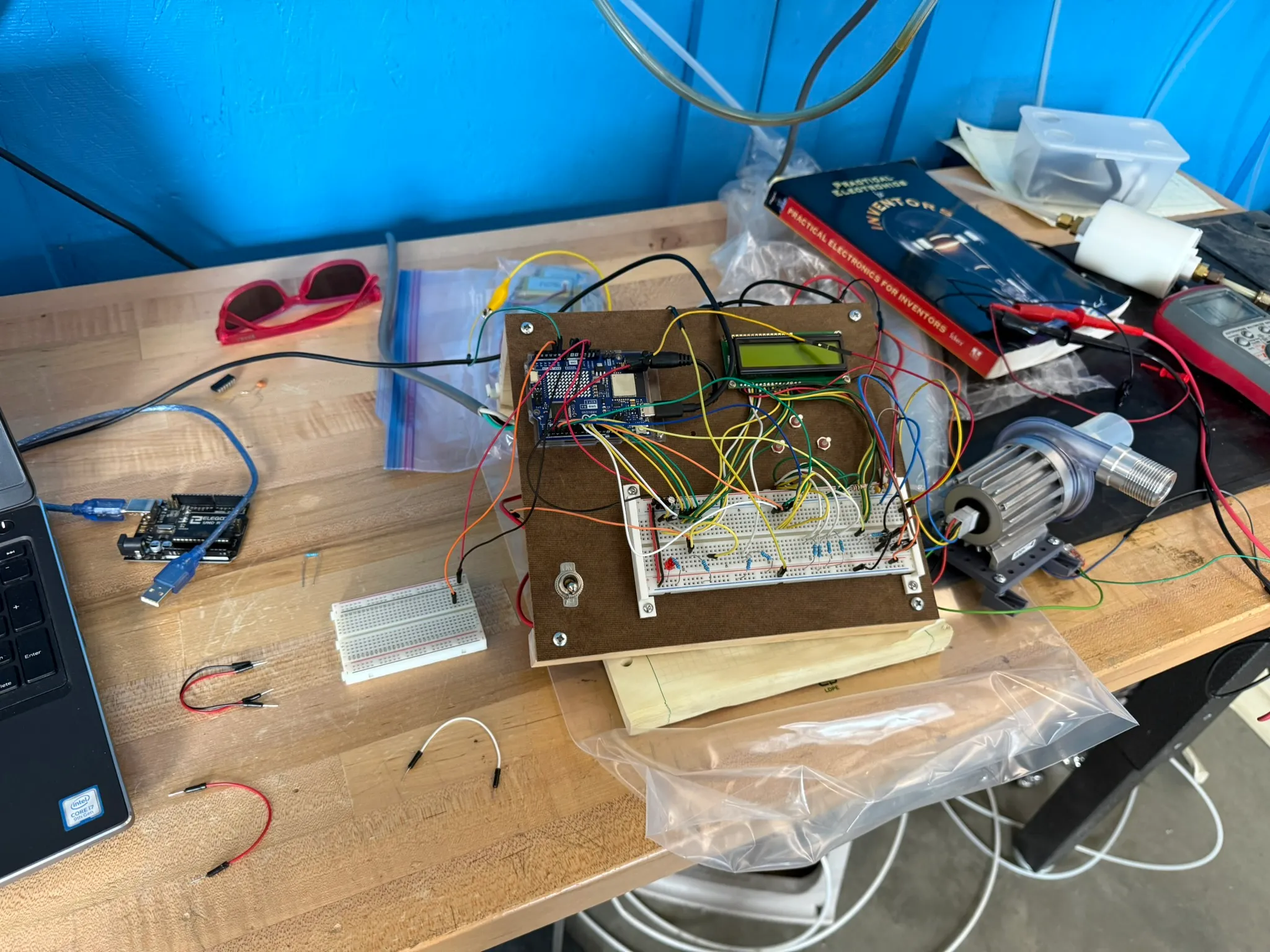 The original controller rig: Arduino, screen, buttons, and breadboard on a plywood panel, wired to the sampler motor