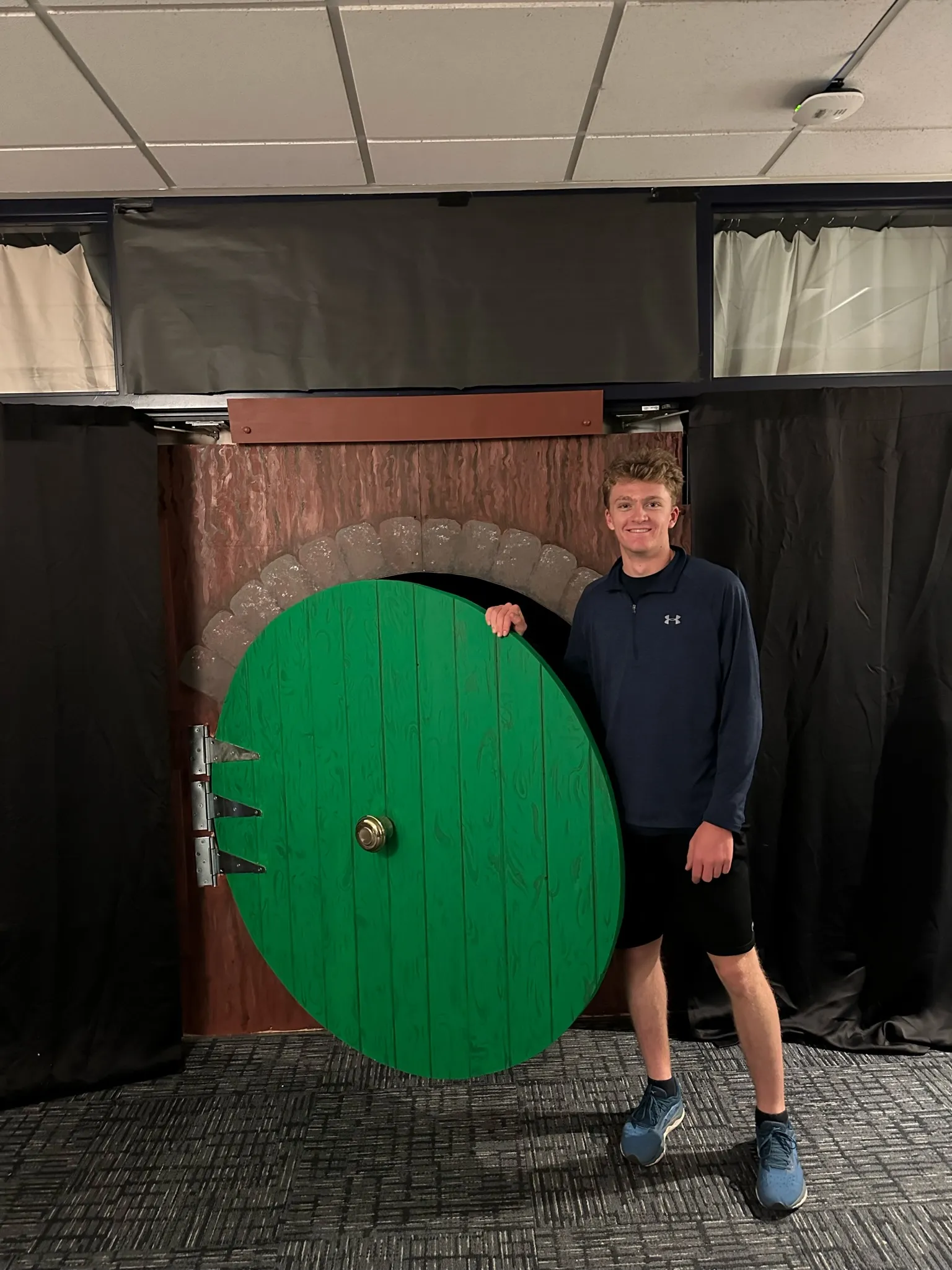Jack standing beside the finished green door for scale