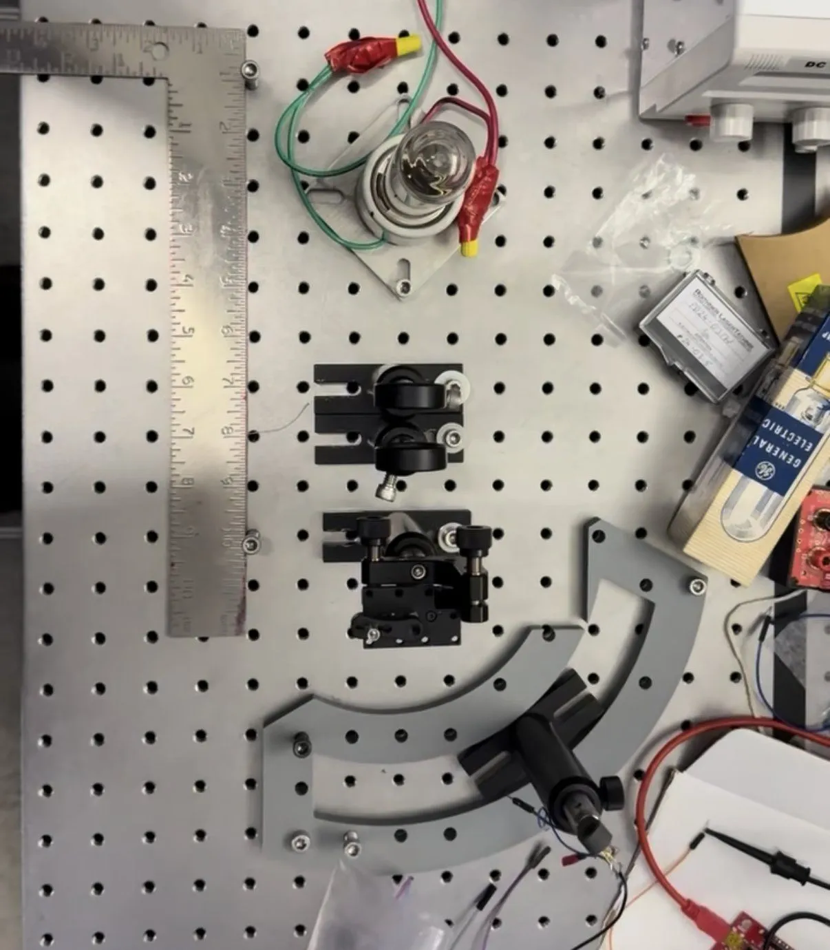 The bench-top setup: an infrared bulb, lens mounts, and the printed arc that holds the photodiode