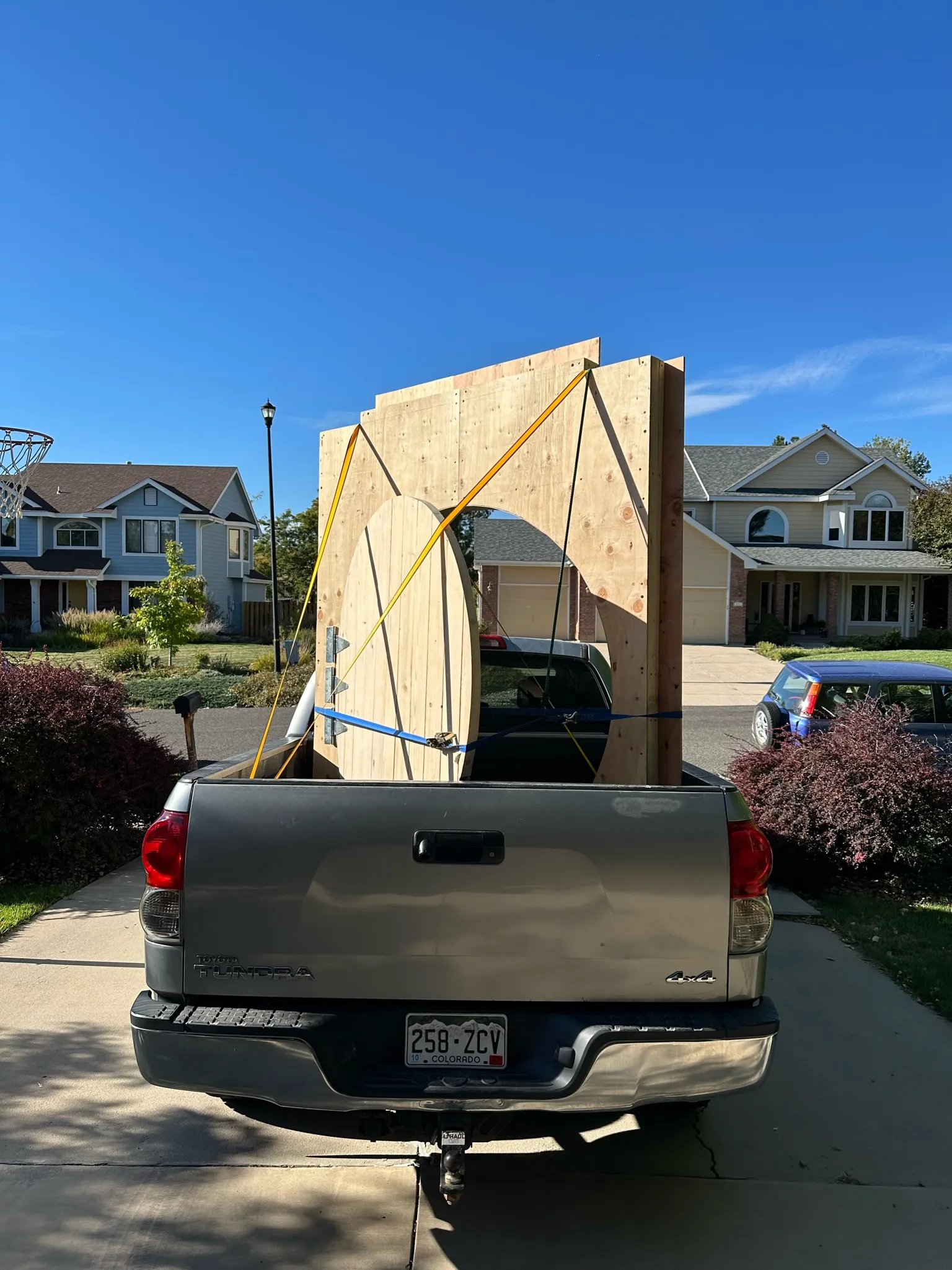 The door panel strapped upright in a pickup bed for transport