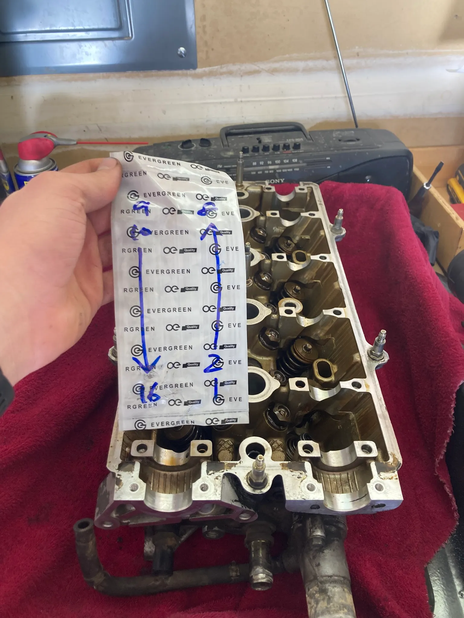 Valvetrain components laid out and labelled by cylinder during disassembly